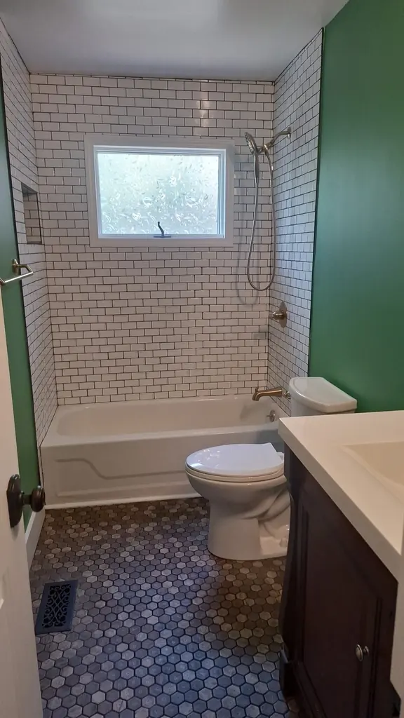The same bathroom finished with green walls, hex tile floor and a new vanity, Knoxville, Tennessee