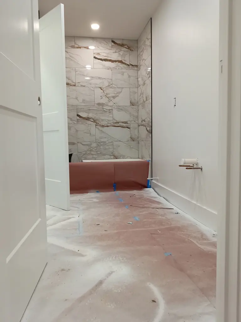 Marble-look tile tub surround in a Knoxville, Tennessee bathroom remodel