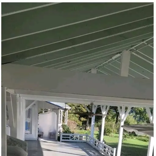 Covered porch with painted columns and a green roof in Knoxville, Tennessee