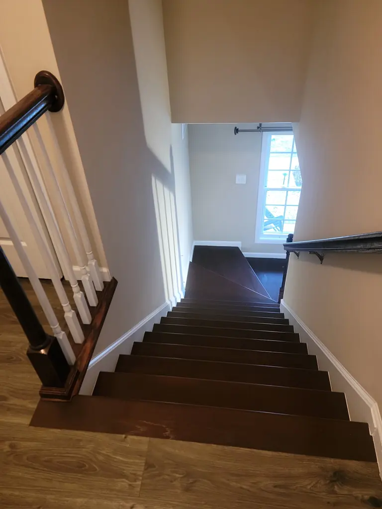 Finished dark hardwood staircase with railing in Knoxville, Tennessee