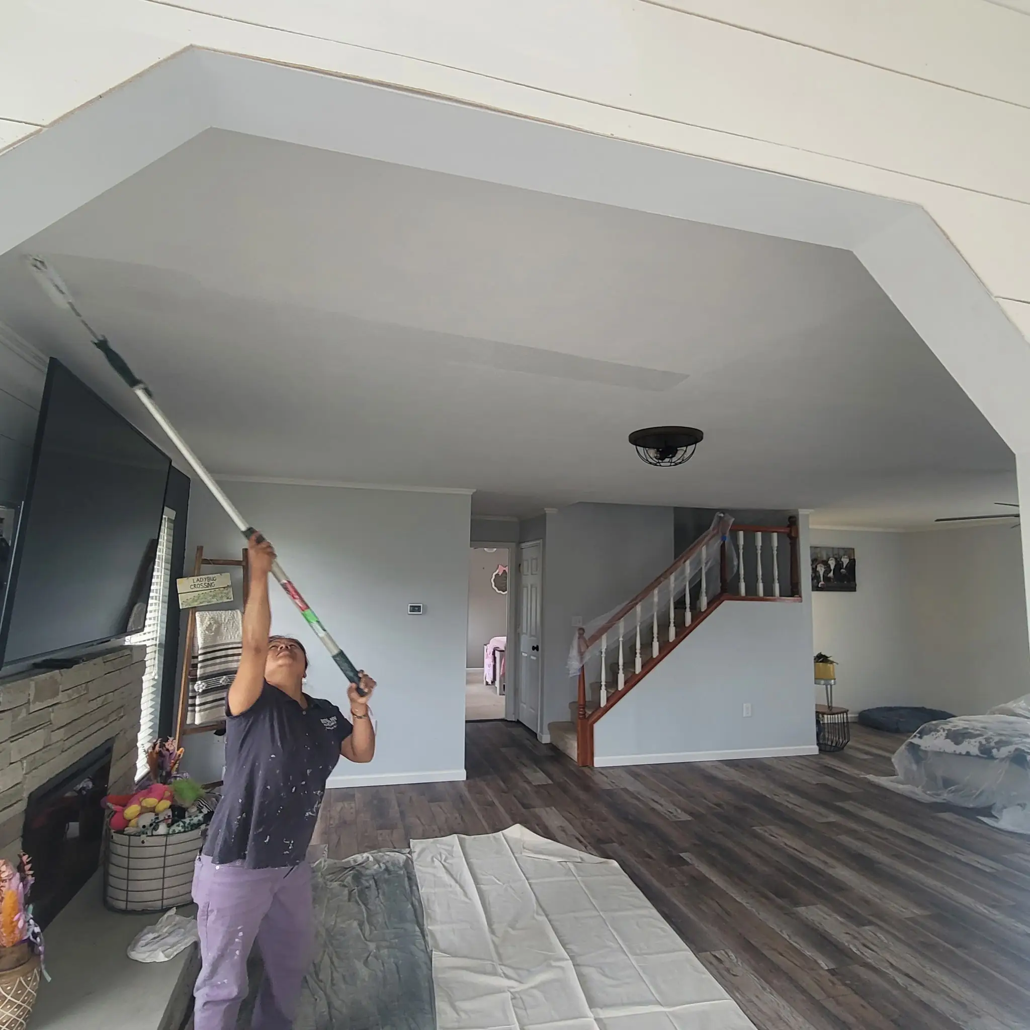 Living room ceiling being rolled during an interior repaint in Knoxville, TN