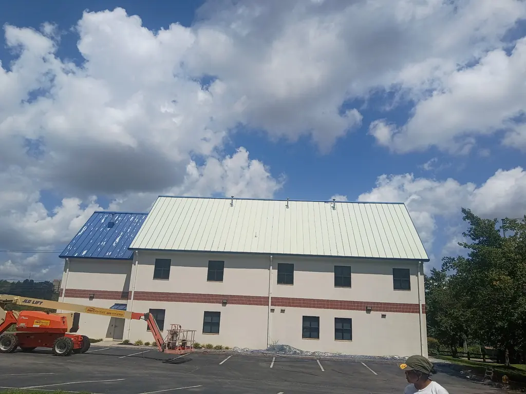 Metal roof coating halfway through on a commercial building in Knoxville, TN